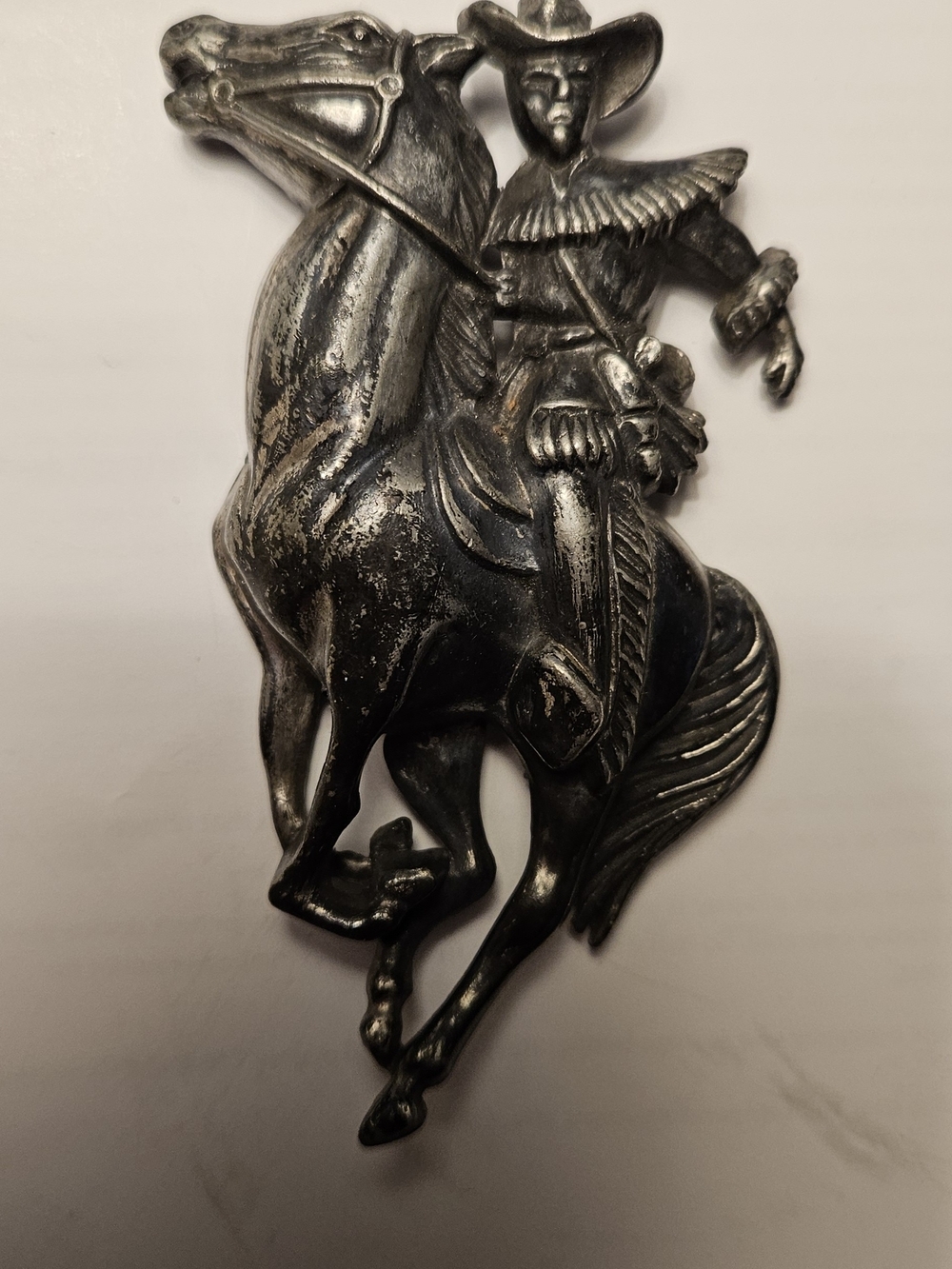 Vintage silver-tone repoussé brooch.
